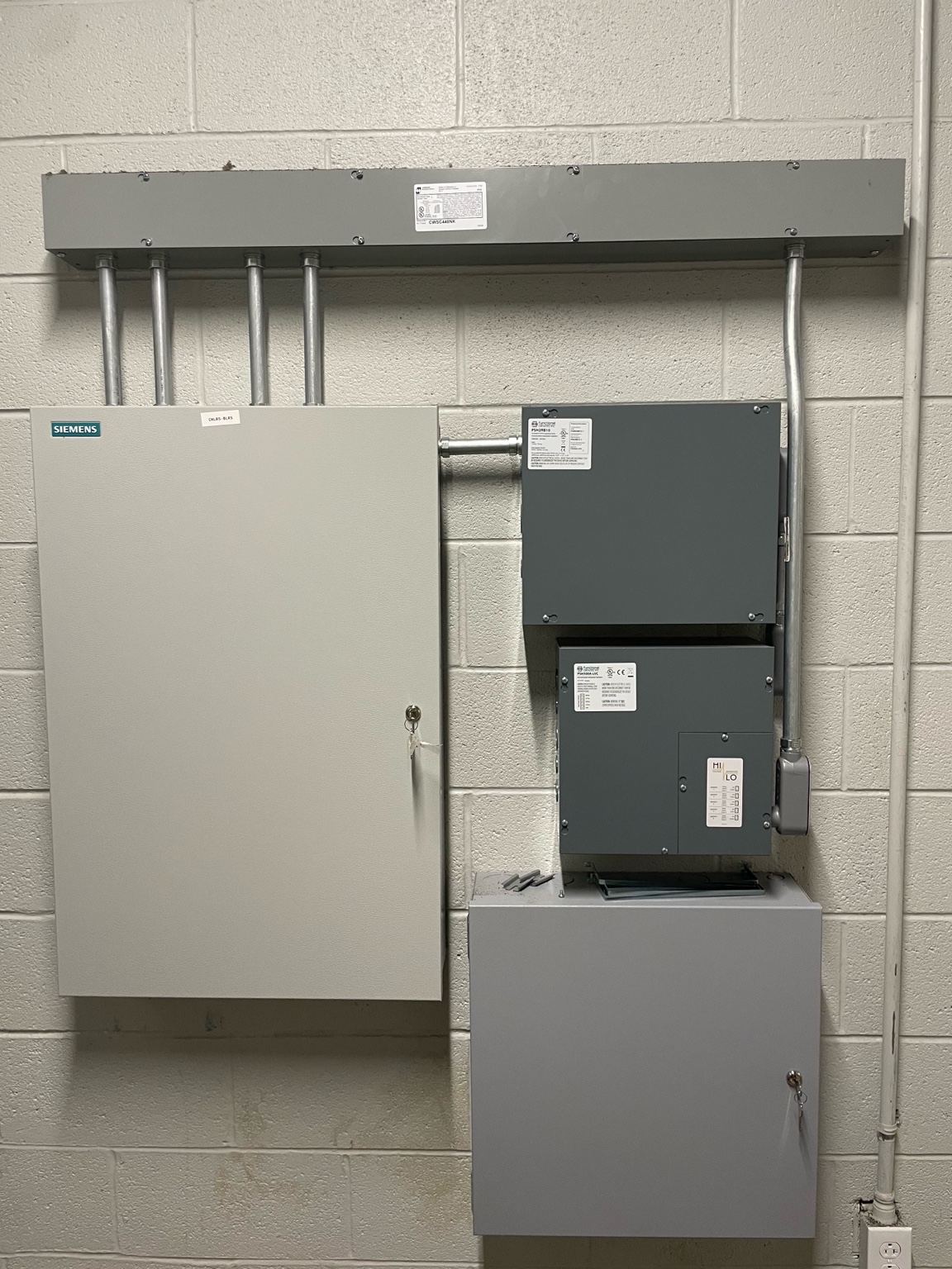 Industrial electrical panel boxes mounted on a concrete wall